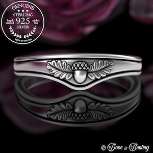 May include: A silver ring with an acorn and oak leaf design. The ring is made of sterling silver and is nickel free.