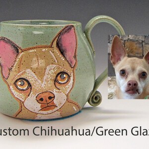 Puede incluir: Una taza de cer&aacute;mica verde con una imagen pintada a mano de un chihuahua. La taza tiene un asa y un esmalte verde moteado. El chihuahua es marr&oacute;n y blanco con orejas rosas.