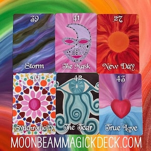 May include: A collection of six colorful tarot cards. The cards feature various illustrations, including a mask, a heart, and an eye. Each card has a title and a number. The website address MOONBEAMMAGICKDECK.COM is at the bottom.