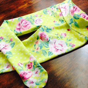 May include: Green leggings with a white polka dot pattern and a floral print featuring pink roses.