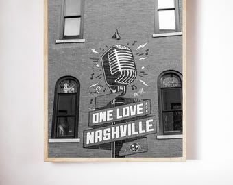 May include: Black and white framed print featuring a brick building with a large microphone graphic. The sign reads "ONE LOVE NASHVILLE" with the Tennessee state flag symbol. The image includes windows and the text "I TN".