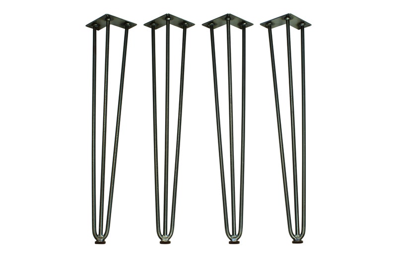 May include: Set of four black metal hairpin legs for furniture. Each leg has three prongs and a flat base.