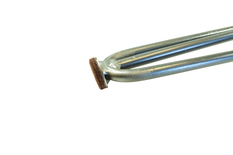 May include: Close-up of a silver heating element with a brown protective covering on the end.