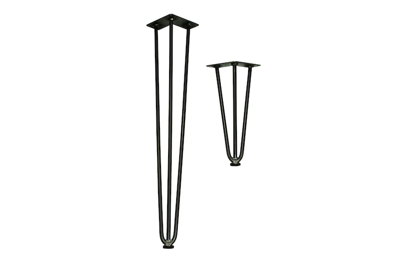 May include: Two black metal hairpin legs for furniture. The taller leg is 45.7 cm tall and the shorter leg is 30.5 cm tall.