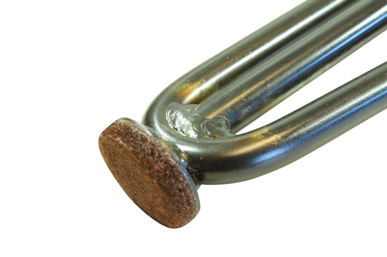 May include: Close-up of a metal furniture leg with a brown felt pad on the bottom. The leg is made of two metal tubes welded together.