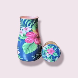 May include: A blue and green floral patterned water bottle with a matching lid. The bottle has a copper colored top.