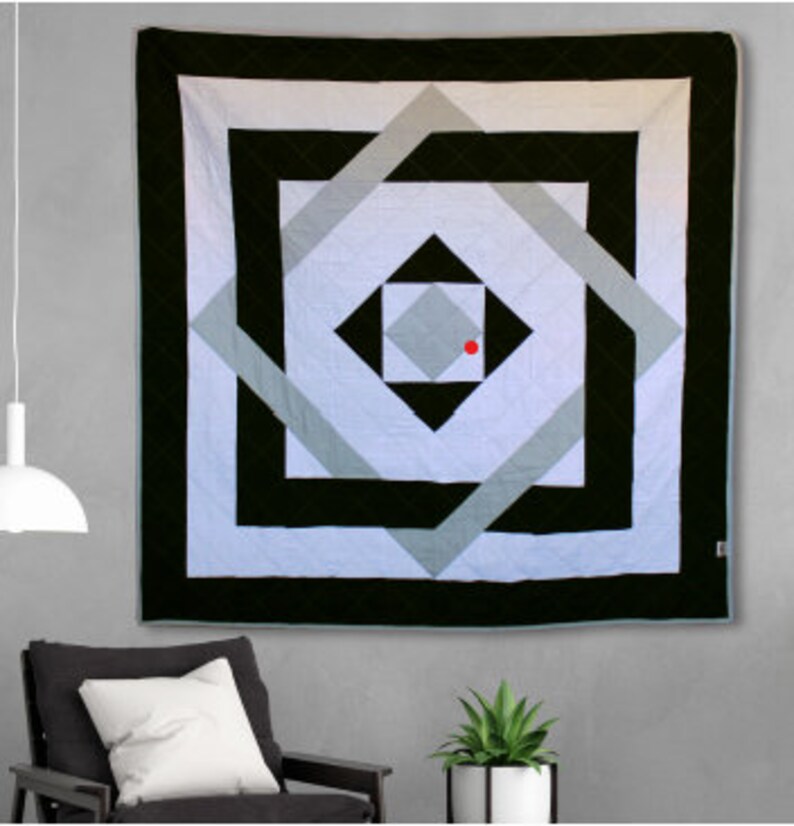 May include: A black and white geometric quilt with a red dot in the center. The quilt features a series of squares and diamonds within squares, creating a layered and intricate design.