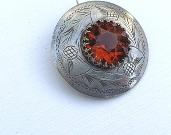 Antique-vintage, Scottish silver-tone metal plaid pin with amber glass centre and thistle design, circa 1910's-30's.