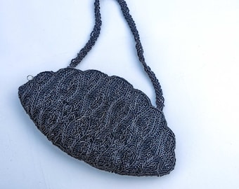 Vintage Art Deco style black beaded evening bag with shaped top and beaded strap, circa 1950's