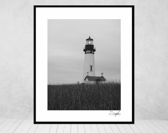 May include: A black and white photograph of a lighthouse standing tall against a cloudy sky. The lighthouse is surrounded by tall grass.