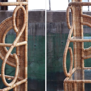 May include: A natural woven rattan shelf unit with three glass shelves. The shelf has a unique design with circular and curved elements.