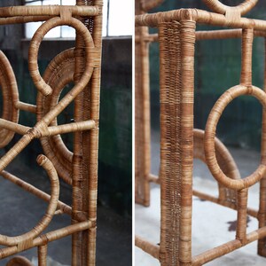 May include: Close-up of a natural woven rattan furniture piece with intricate circular designs. The furniture is made of light brown rattan and has a natural finish.