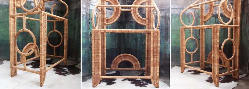 May include: A tall, natural wicker shelf unit with a geometric design. The shelf has three levels and is made of woven rattan.