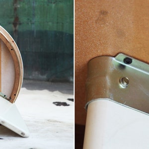 May include: The underside of a white and wood half-round table with a metal bracket attached to the underside of the table top.