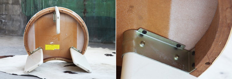 May include: The underside of a white and wood half-round table with a metal bracket attached to the underside of the table top.