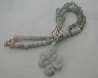 Carved jade infinity knot pendant on rough cut aquamarine beads necklace , eternal love knot /endless knot /unending love knot / mystic knot