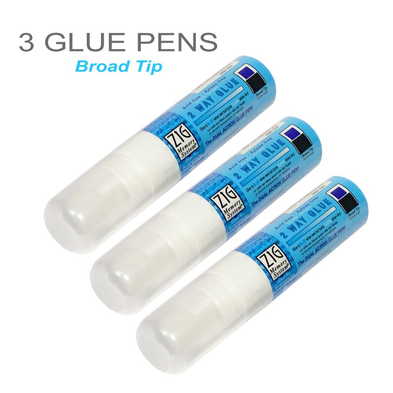 May include: Three white glue pens with blue labels that say "Zig Memory System 2 Way Glue The Dual Action Glue Pen" and "Broad Tip".