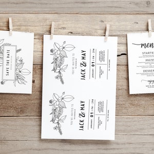 K&ouml;nnte beinhalten: Drei wei&szlig;e Karten mit schwarzer Tinte, die an einer Schnur mit W&auml;scheklammern h&auml;ngen. Die erste Karte sagt "Save the Date" mit einem floralen Design. Die zweite und dritte Karte sind Hochzeitseinladungen f&uuml;r Jack und May, mit Datum und Uhrzeit der Hochzeit. Die dritte Karte ist ein Men&uuml; mit den Worten "Speisekarte", "Vorspeisen", "Hauptgerichte", "Nachspeisen" und "Guten Appetit".