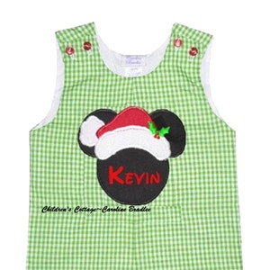 May include: Green and white gingham overall shorts with a black and red Mickey Mouse head with a Santa hat and the name "Kevin" embroidered on the front.