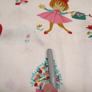 May include: White fabric with a repeating pattern of children and flowers. The children are dressed in red, pink, and green. The flowers are red, yellow, and blue.