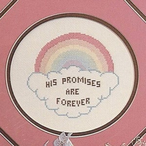May include: A framed cross-stitch design with a rainbow over a cloud and the text "His Promises Are Forever".