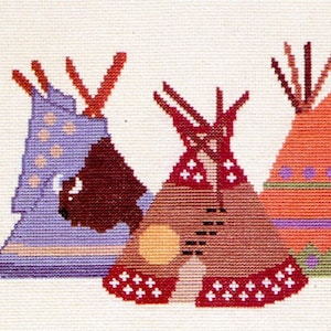 May include: Three colorful teepees with different patterns and designs. The teepees are made of fabric and have a brown base. The teepees are arranged in a row from left to right.