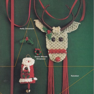 May include: A close-up of three crocheted Christmas ornaments: a reindeer, a holly sprig, and a green wreath. The reindeer has a red nose and brown antlers. The ornaments are hanging from a red ribbon.