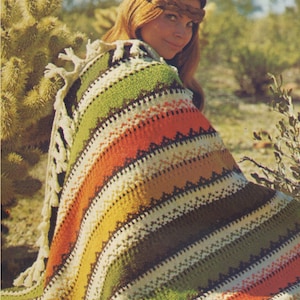 May include: A colorful striped crochet blanket with fringe. The blanket is made with a variety of colors, including green, orange, yellow, and brown. The blanket is folded and draped over a person's shoulders.