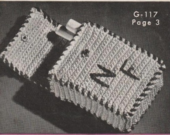 May include: A crocheted cigarette case with a black and white pattern. The case has a flap that closes with a button. The case is labeled "G-117 Page 3".