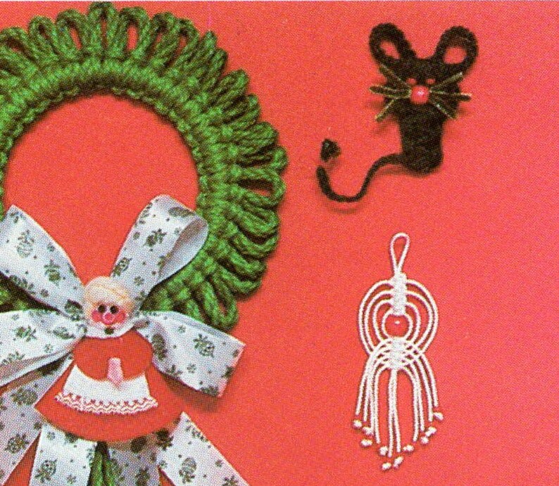 May include: A green yarn wreath with a white ribbon and a red and white doll ornament. There is also a black yarn mouse and a white yarn tassel ornament.
