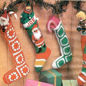 May include: Four crocheted Christmas stockings with different designs. One stocking is red and white with a crocheted flower pattern. Another stocking is green and white with a crocheted square pattern. The third stocking is red and green with a Santa Claus design. The fourth stocking is red and green with a Christmas tree design.