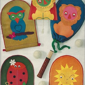 May include: Five felt bags with different animal and nature designs. The bags are yellow, blue, orange, green, and red. Each bag has a drawstring and is decorated with felt appliques. The bags are arranged on a white surface with a wooden tennis racket and two white balls.