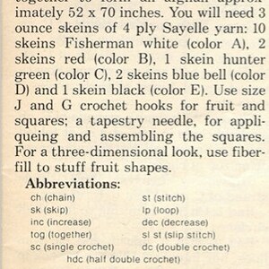 May include: A printed instruction sheet for a crochet afghan project. The text details materials including 3 ounce skeins of 4 ply Sayelle yarn in fisherman white, red, hunter green, blue bell, and black, plus size J and G hooks and fiberfill.