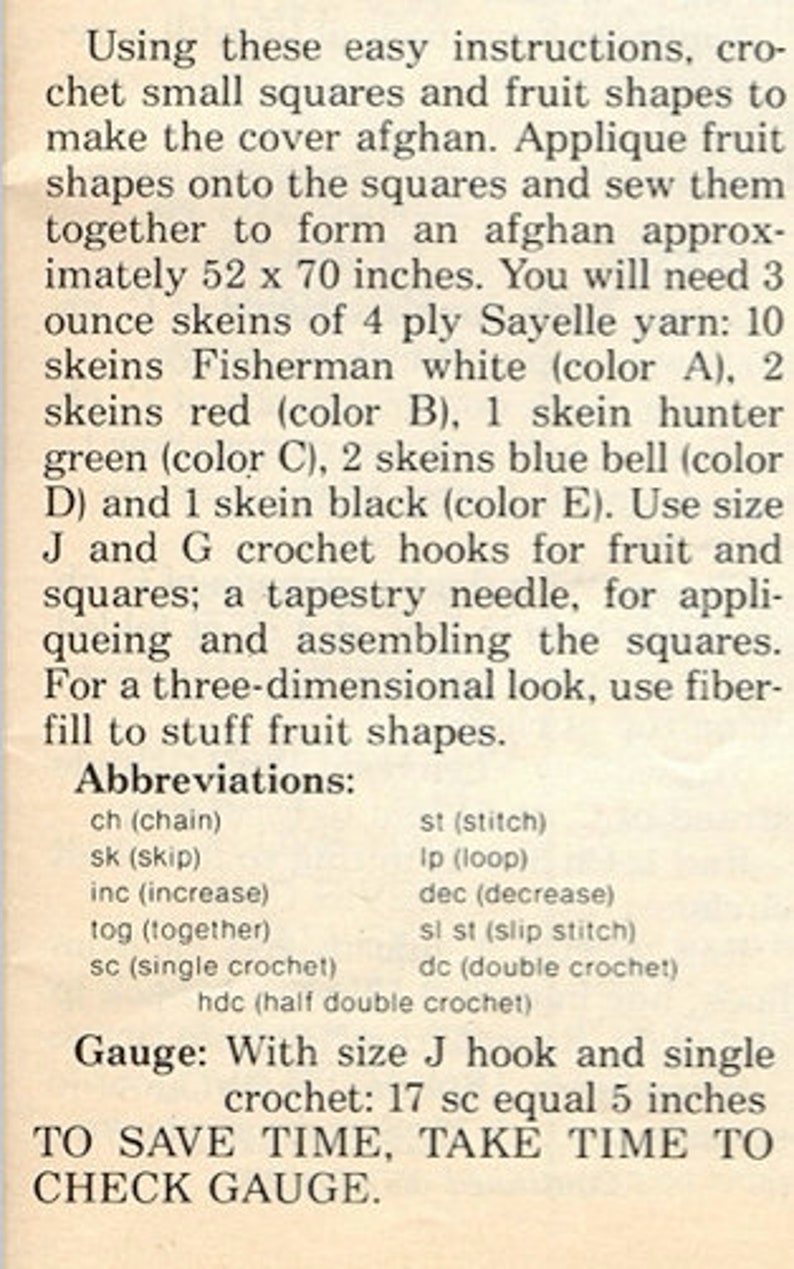 May include: A printed instruction sheet for a crochet afghan project. The text details materials including 3 ounce skeins of 4 ply Sayelle yarn in fisherman white, red, hunter green, blue bell, and black, plus size J and G hooks and fiberfill.