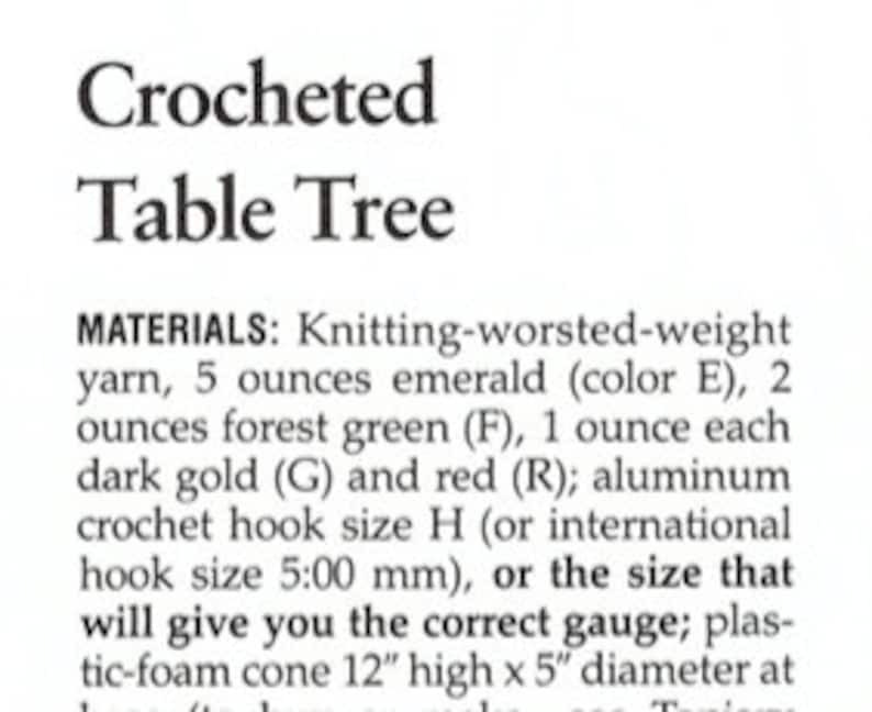 May include: A text document titled Crocheted Table Tree listing materials including 5 ounces of emerald yarn, 2 ounces of forest green yarn, 1 ounce each of dark gold and red yarn, a size H crochet hook, and a 12 inch high by 5 inch diameter cone.