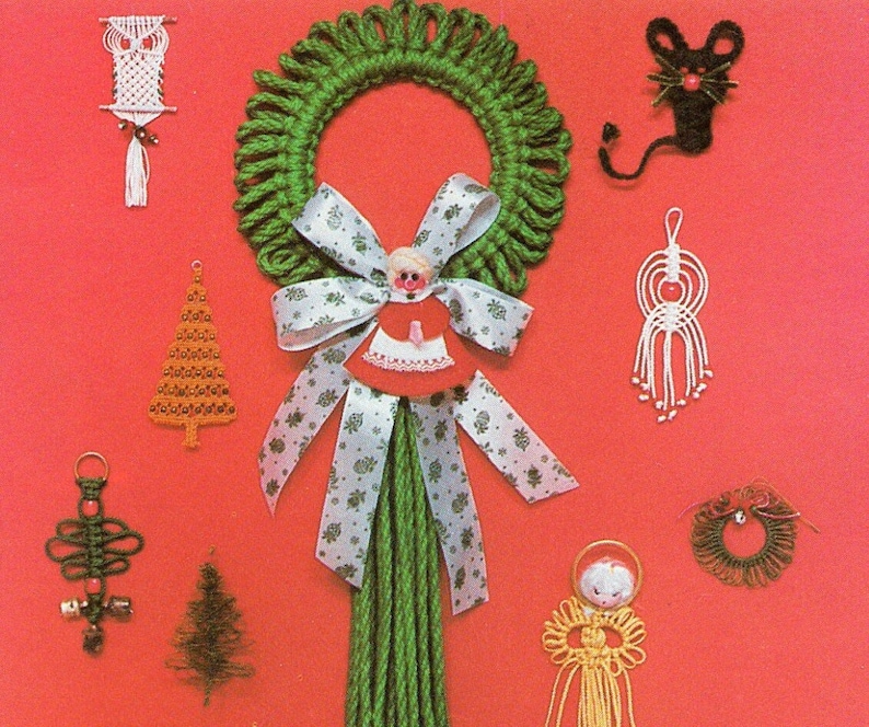 May include: A green yarn wreath with a white and green ribbon and a doll with a red dress and a white apron. There are other yarn ornaments including a Christmas tree, an owl, a mouse, an angel, and a ring.