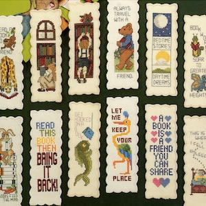May include: Ten colorful cross-stitch bookmark designs with various themes, including reading, travel, bedtime, and friendship. Each bookmark features a different image and text, such as "Read a book to a friend", "Always travel with a friend", and "A book is a friend you can share".