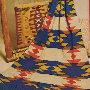 May include: A woven blanket with a Southwestern design in shades of blue, yellow, orange, and red. The blanket has a fringe border and is draped over a wooden loom.