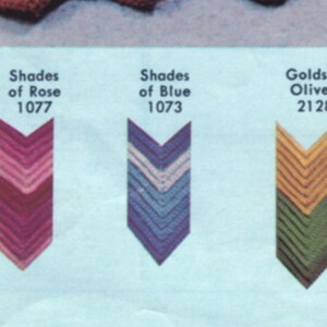 May include: A color chart featuring five chevron-shaped color swatches. The swatches display various color combinations, including blue and green, shades of rose, shades of blue, golds and olives, and shades of brown. Each swatch has a corresponding number.