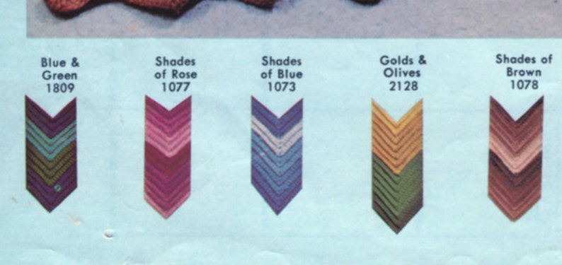 May include: A color chart featuring five chevron-shaped color swatches. The swatches display various color combinations, including blue and green, shades of rose, shades of blue, golds and olives, and shades of brown. Each swatch has a corresponding number.