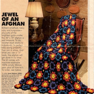 May include: A crochet afghan pattern featuring a colorful floral design in shades of blue, red, yellow, and purple. The afghan is draped over a wooden rocking chair. The text "Jewel of an Afghan" is printed on the page.