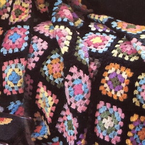 Vintage 1970s granny square crochet afghan pattern that is funky with black edging and bold center colors; a fun craft project.