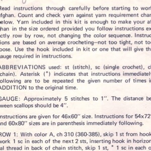 May include: A close-up of a printed page with crochet instructions. The text includes abbreviations, gauge information, and instructions for different sizes, including 46x60 inches, 54x72 inches, and 60x80 inches. The instructions are for making an afghan.