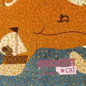 May include: A whimsical fabric art piece featuring a large orange whale with a smiling face and a small sailboat. The whale is above blue patterned water, with the text "pearlshore cat" in the lower right corner.