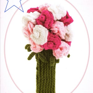 May include: A crocheted bouquet of pink, white, and light pink flowers in a green crocheted vase.