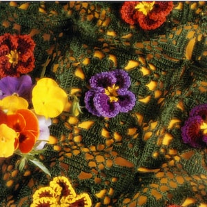 May include: Green crochet doily with a floral design featuring purple, yellow, and red pansies.