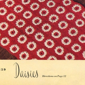 May include: A crochet pattern for a red and white blanket with a daisy design. The pattern is called "Daisies" and the directions are on page 12.