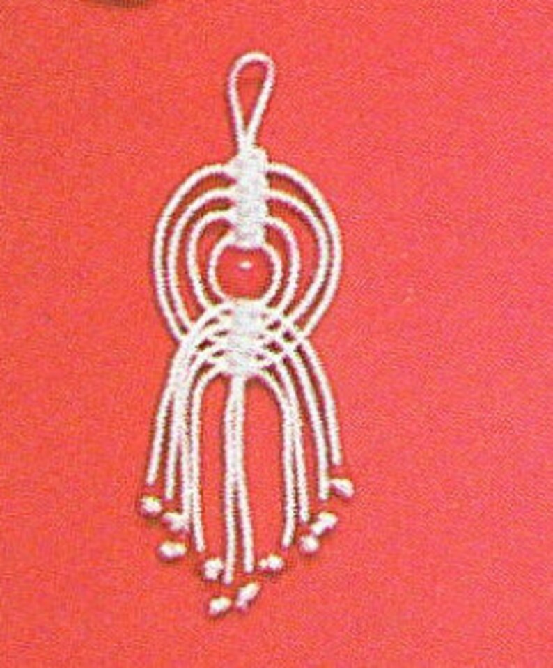 May include: White macrame keychain with a red bead in the center and a loop at the top.