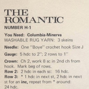 Pu&ograve; includere: Primo piano di una pagina stampata con il titolo "THE ROMANTIC" e il numero "H-1". Il testo fornisce istruzioni per un progetto all'uncinetto, tra cui filato, dimensioni dell'uncinetto e dettagli del punto. Il testo include anche il marchio "Columbia-Minerva".