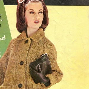 May include: A woman wearing a brown knitted cardigan with a black purse. The cardigan has a button closure and a collar.